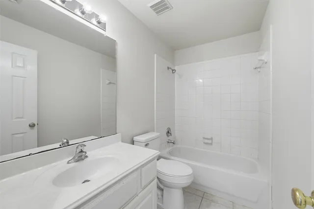 a bathroom with a toilet a sink and bathtub