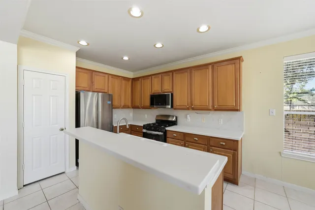 a kitchen with stainless steel appliances a refrigerator sink and microwave