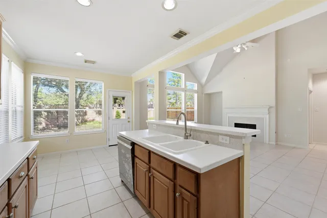 a kitchen with a stove sink and cabinets