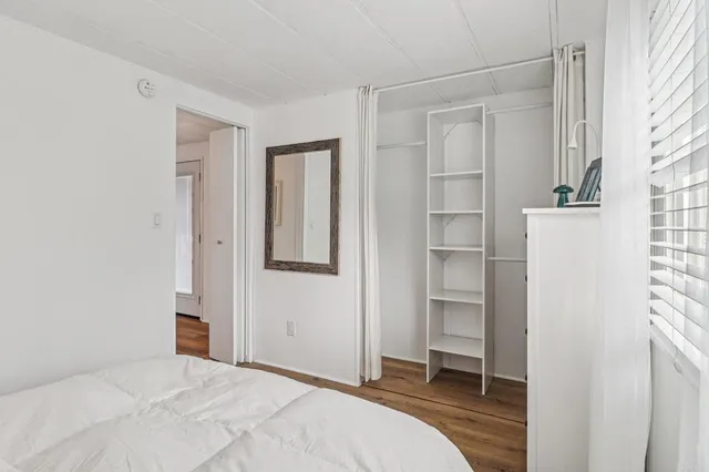 a bedroom with a bed and a closet