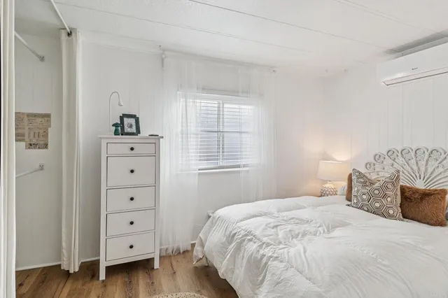 a bedroom with a bed and a dresser