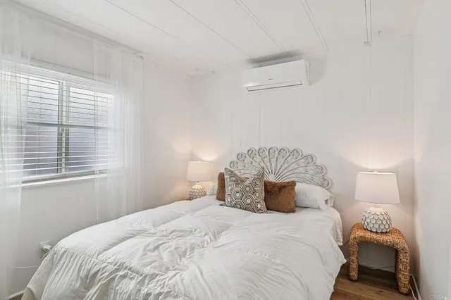 a bedroom with a bed and window