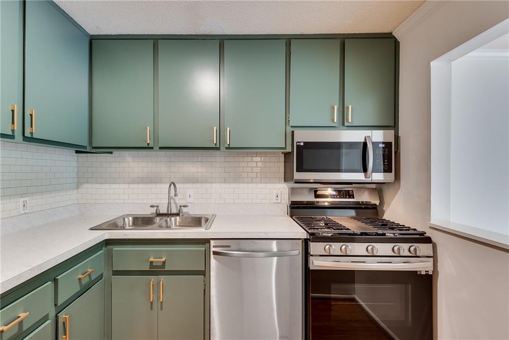 a kitchen with a stove and a sink