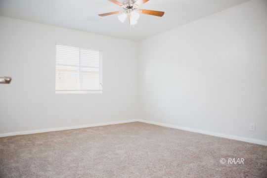 929 South Farragut Street Ridgecrest, CA 93555 - Photo 32 of 35 an empty room with a window and a ceiling fan