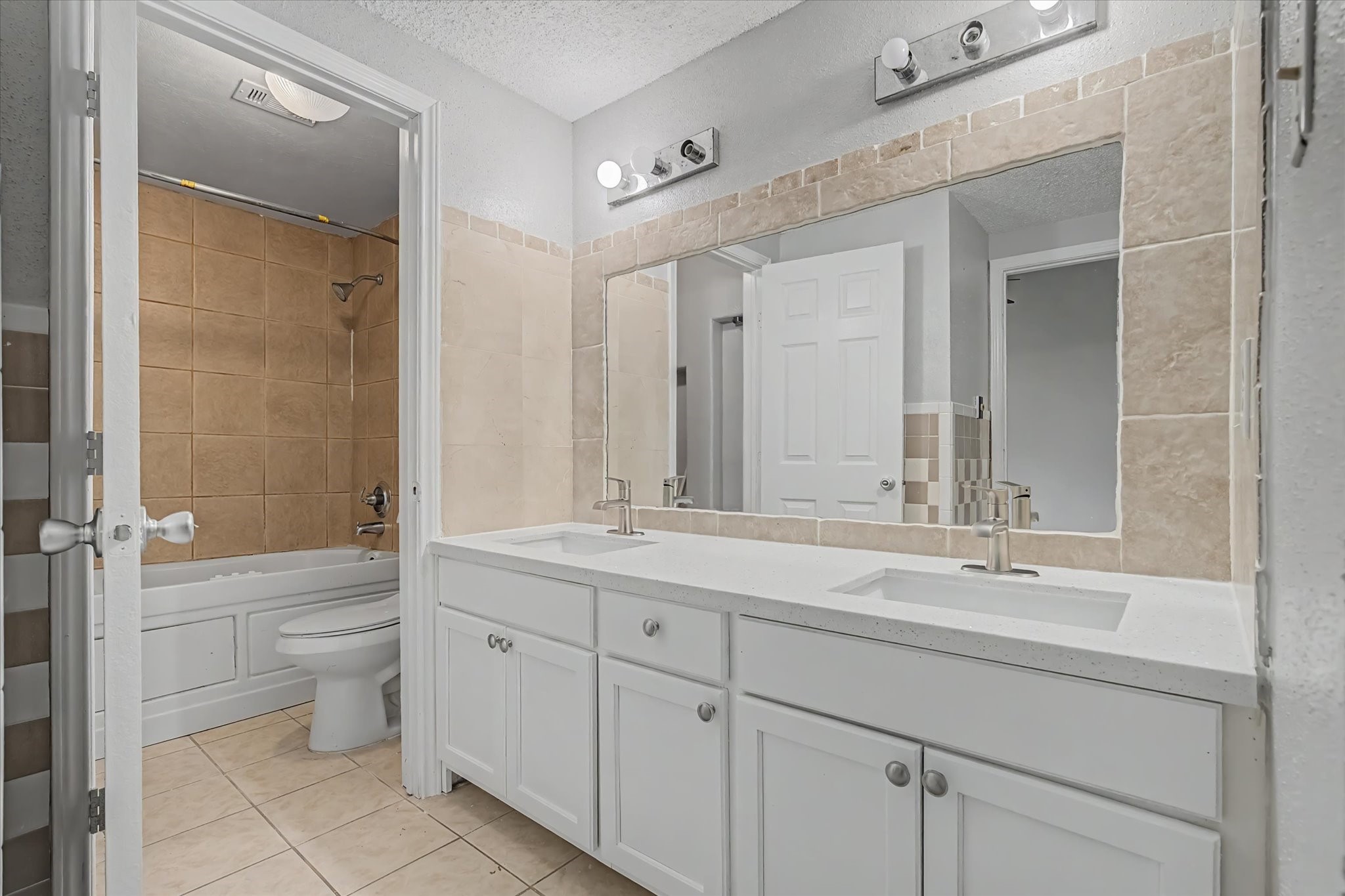 7330 South Dairy Ashford Road Houston, TX 77072 - Photo 24 of 33 a bathroom with a double vanity sink toilet mirror and bathtub