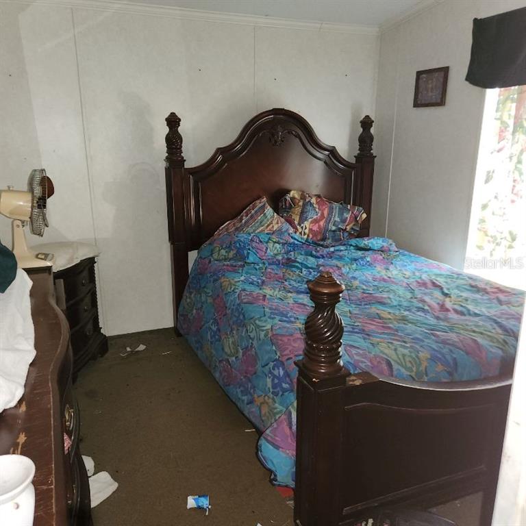 114 Singleton Avenue Arcadia, FL 34266 - Photo 3 of 9 a bed sitting in a bedroom next to a window