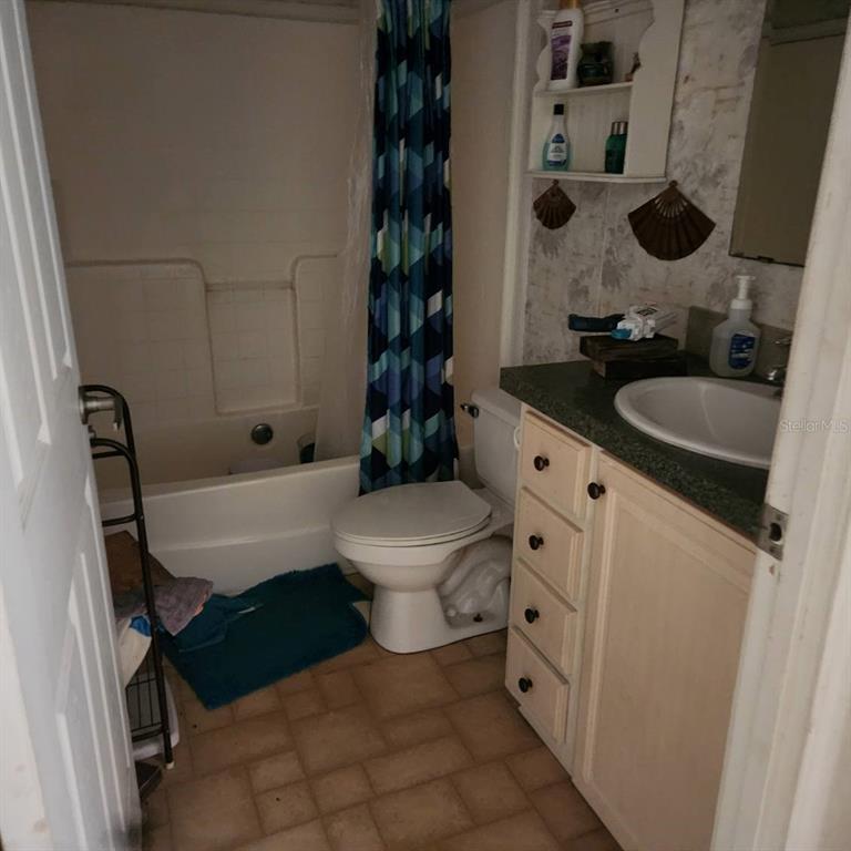 114 Singleton Avenue Arcadia, FL 34266 - Photo 4 of 9 a bathroom with a granite countertop toilet sink and mirror