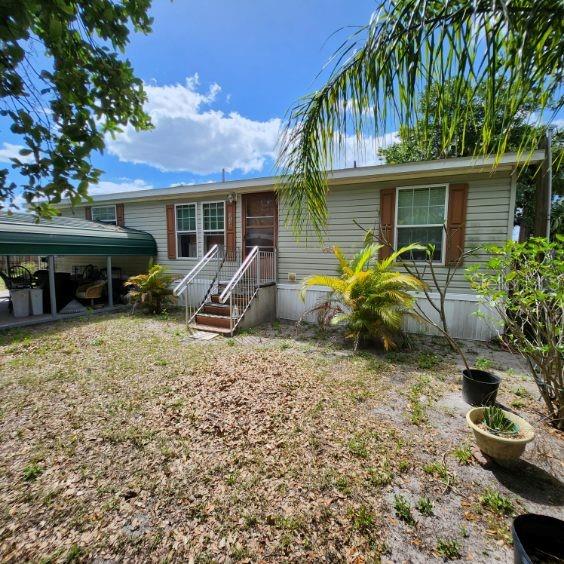 114 Singleton Avenue Arcadia, FL 34266 - Photo 9 of 9 a backyard of a house with yard table and chairs