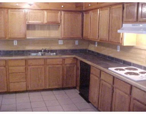 a kitchen with stainless steel appliances granite countertop a sink a stove and cabinets