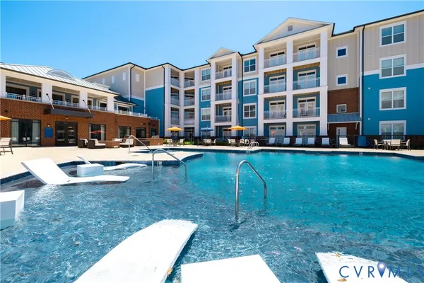 a swimming pool with outdoor seating and yard