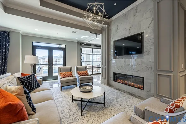 a living room with furniture a flat screen tv and a fireplace