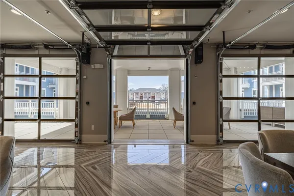 a view of a hallway with wooden floor and windows