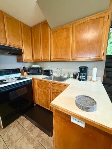 a kitchen with a sink and a stove top oven