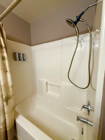 a bathroom with a sink a bath tub and a shower