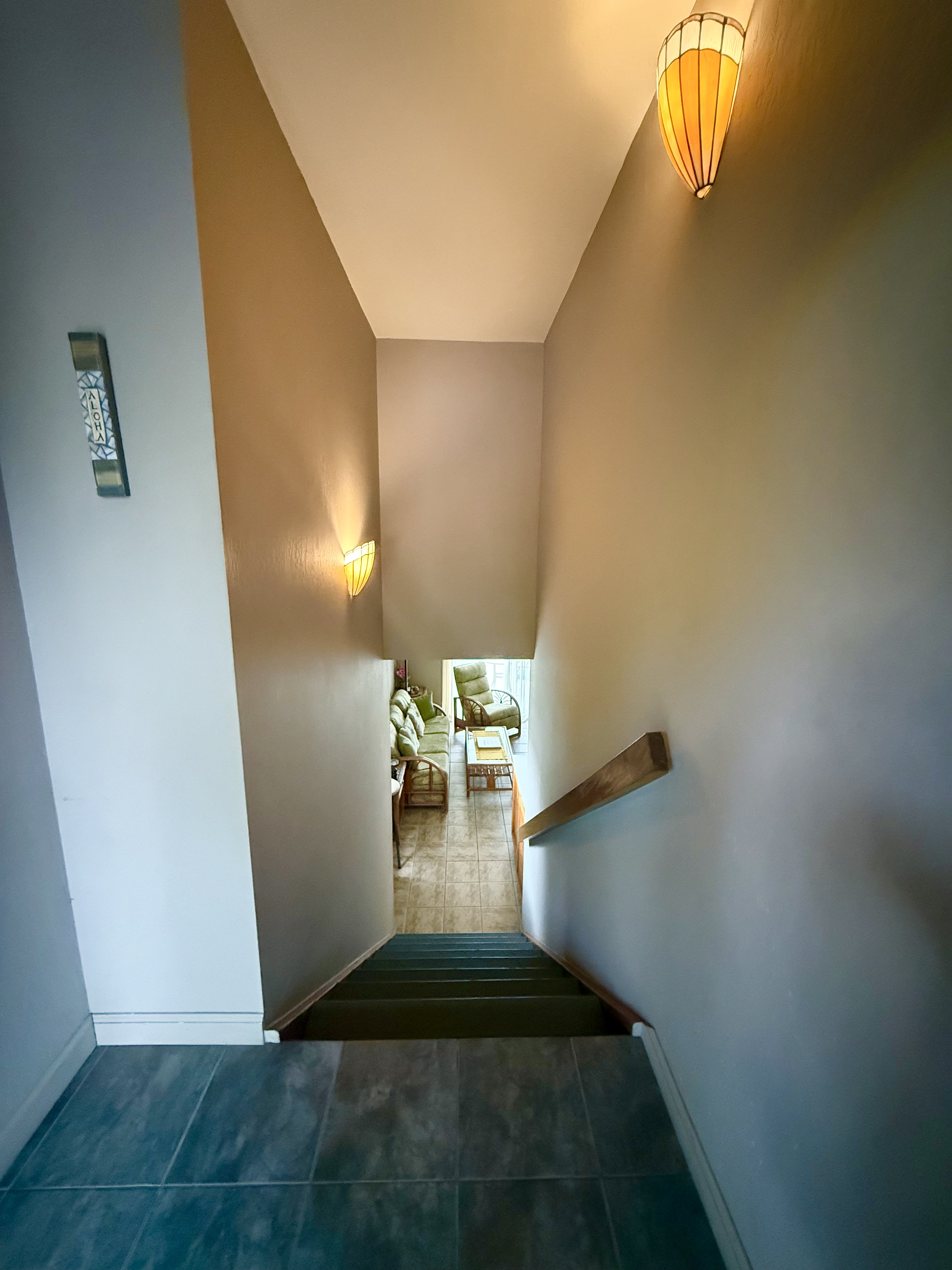 95-788 Ninole Loop Road, Unit 39 Naalehu, HI 96772 - Photo 10 of 15 a view of a livingroom with wooden floor and a staircase