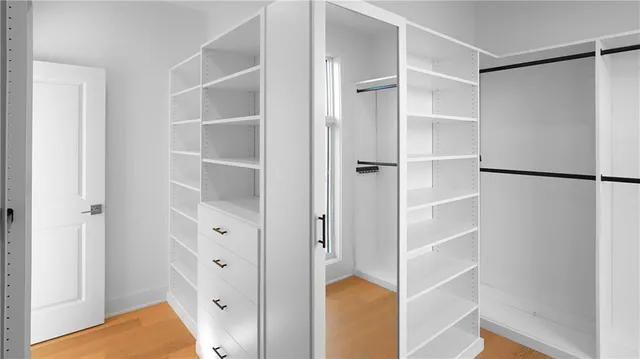 a view of walk in closet with empty racks