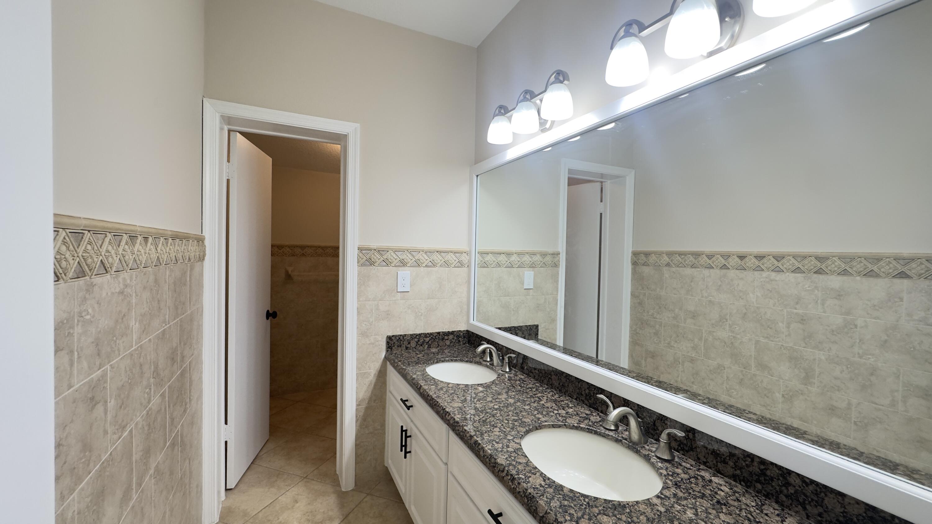 11330 Timber Lodge Terrace Boca Raton, FL 33428 - Photo 13 of 23 a bathroom with a granite countertop sink a toilet and shower