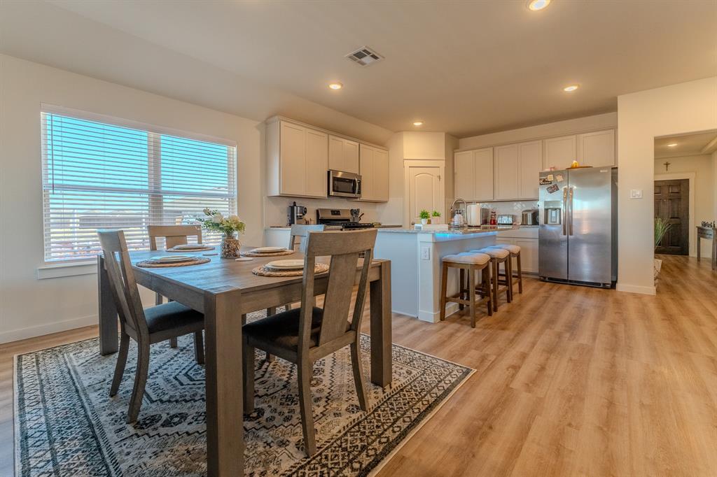 1571 Gentle Night Drive Forney, TX 75126 - Photo 5 of 15 a view of a dining room with furniture window and wooden floor