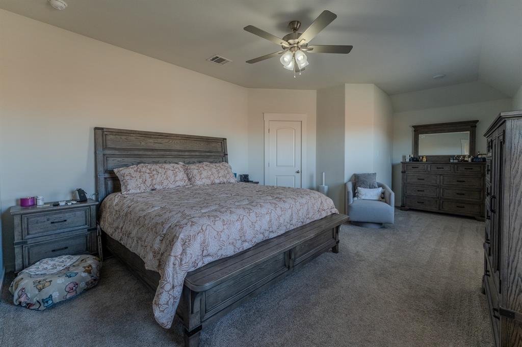 1571 Gentle Night Drive Forney, TX 75126 - Photo 6 of 15 a bedroom with a bed and a chandelier