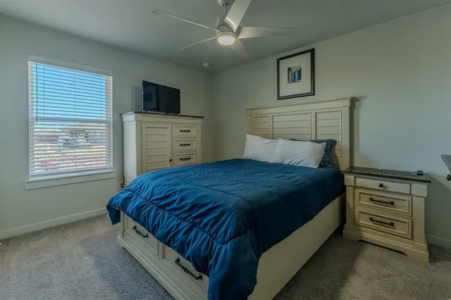 a bedroom with a bed and a television