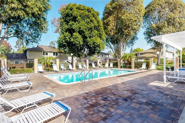 a view of a patio with a table and chairs and couches with wooden floor and fence
