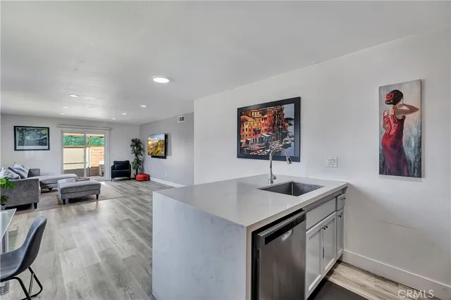 a kitchen with stainless steel appliances granite countertop a sink and a refrigerator