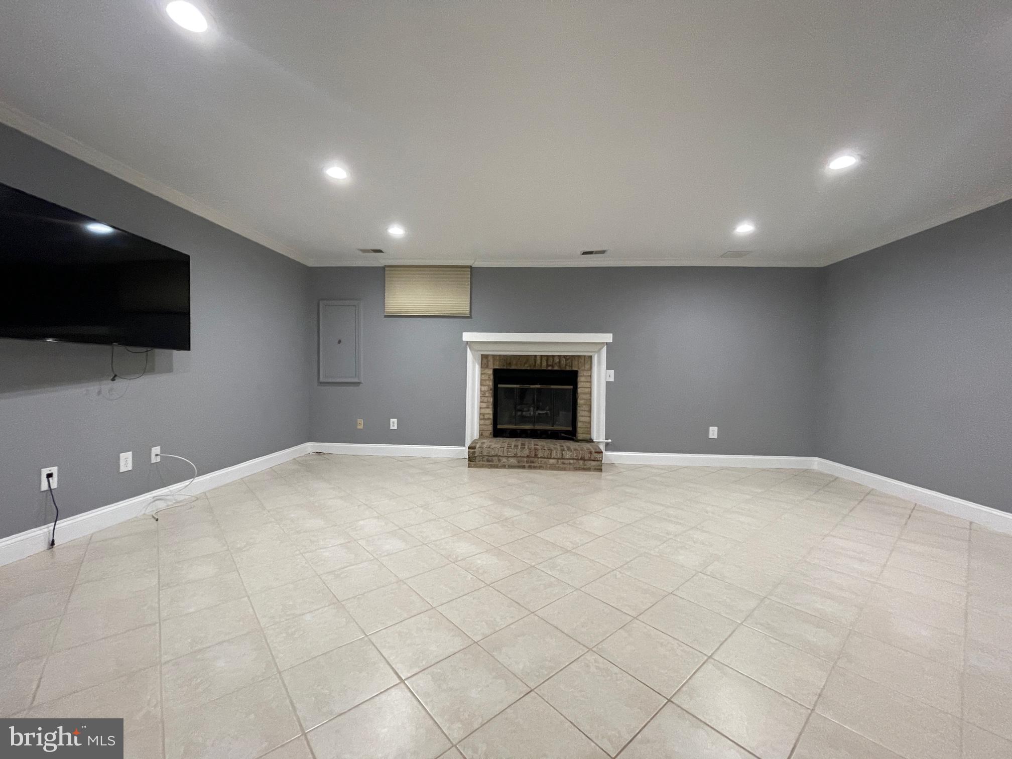 308 Crescendo Way Silver Spring, MD 20901 - Photo 13 of 26 an empty room with fireplace and tv