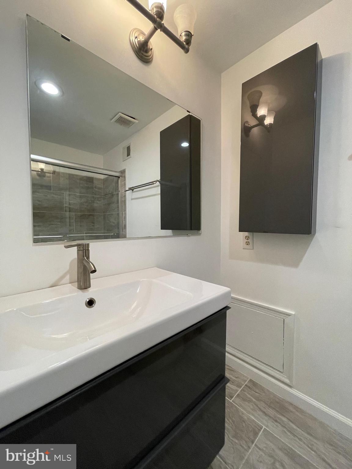 308 Crescendo Way Silver Spring, MD 20901 - Photo 19 of 26 a bathroom with a sink and a mirror