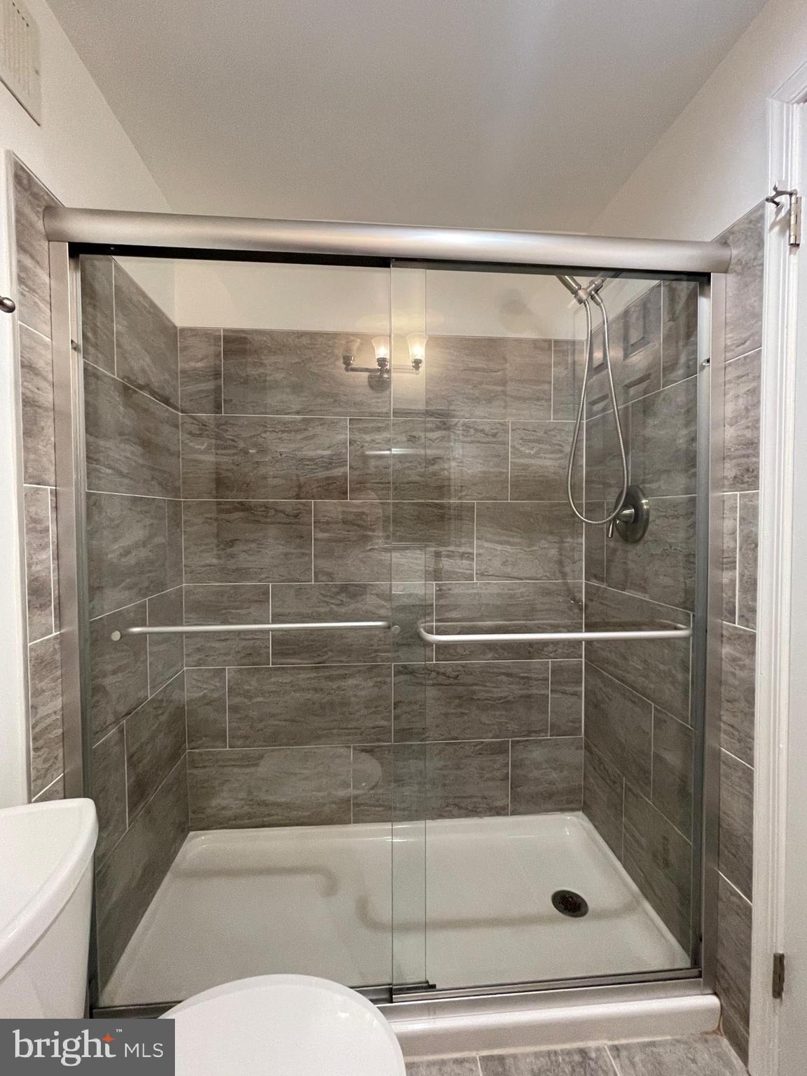 308 Crescendo Way Silver Spring, MD 20901 - Photo 20 of 26 a bathroom with a shower and toilet