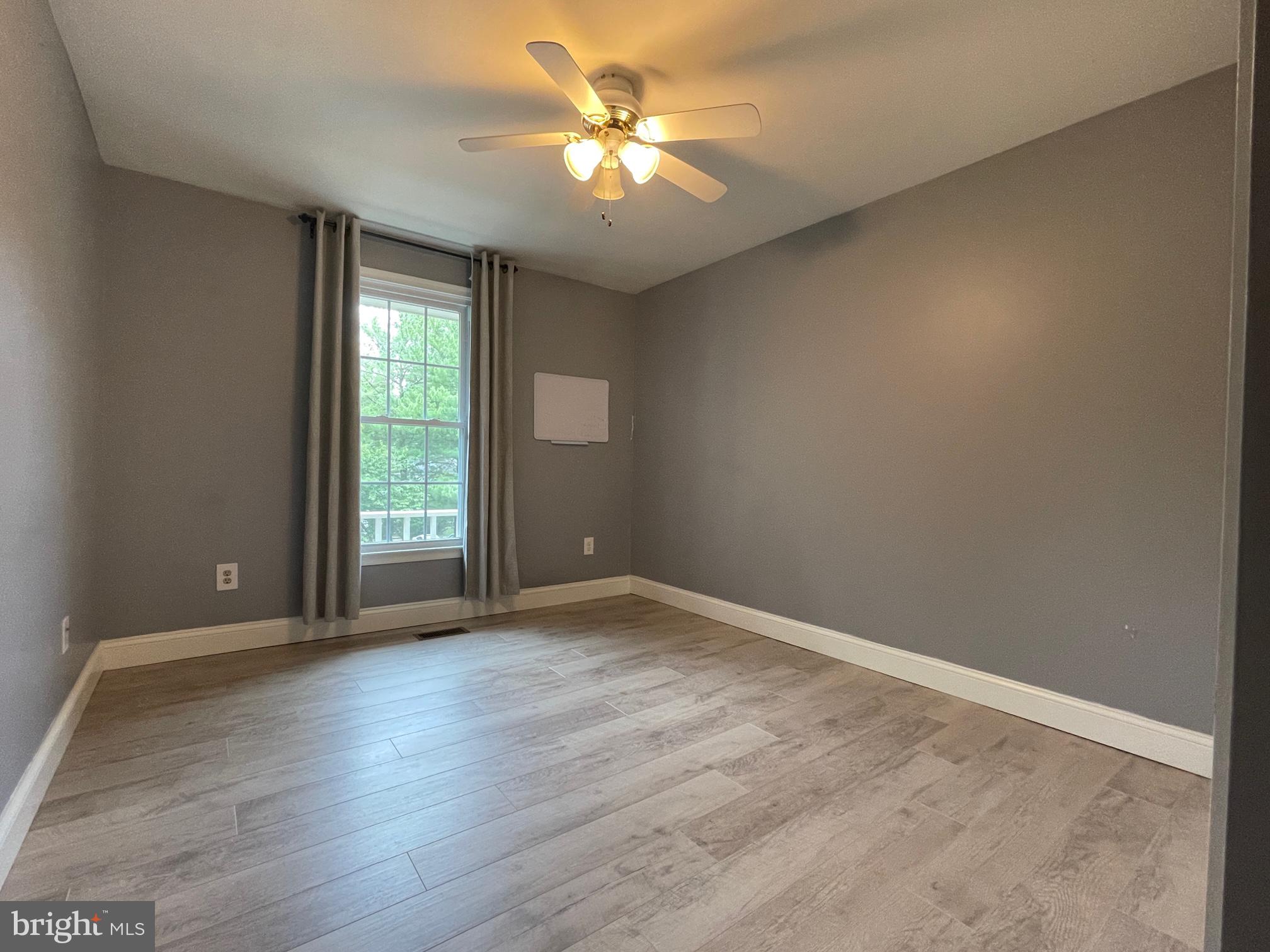 308 Crescendo Way Silver Spring, MD 20901 - Photo 22 of 26 wooden floor in an empty room with a window