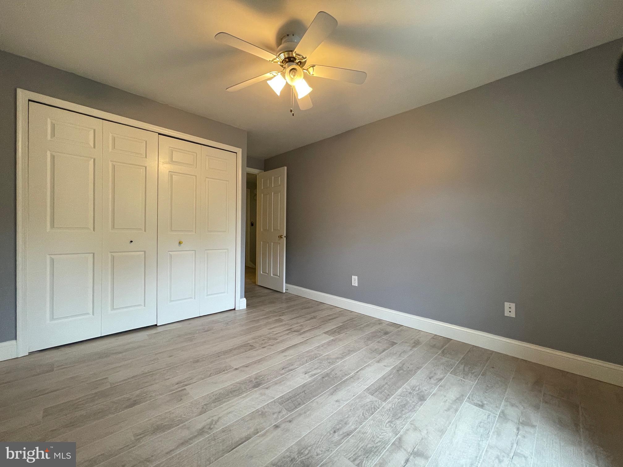 308 Crescendo Way Silver Spring, MD 20901 - Photo 23 of 26 an empty room with a ceiling fan and a window