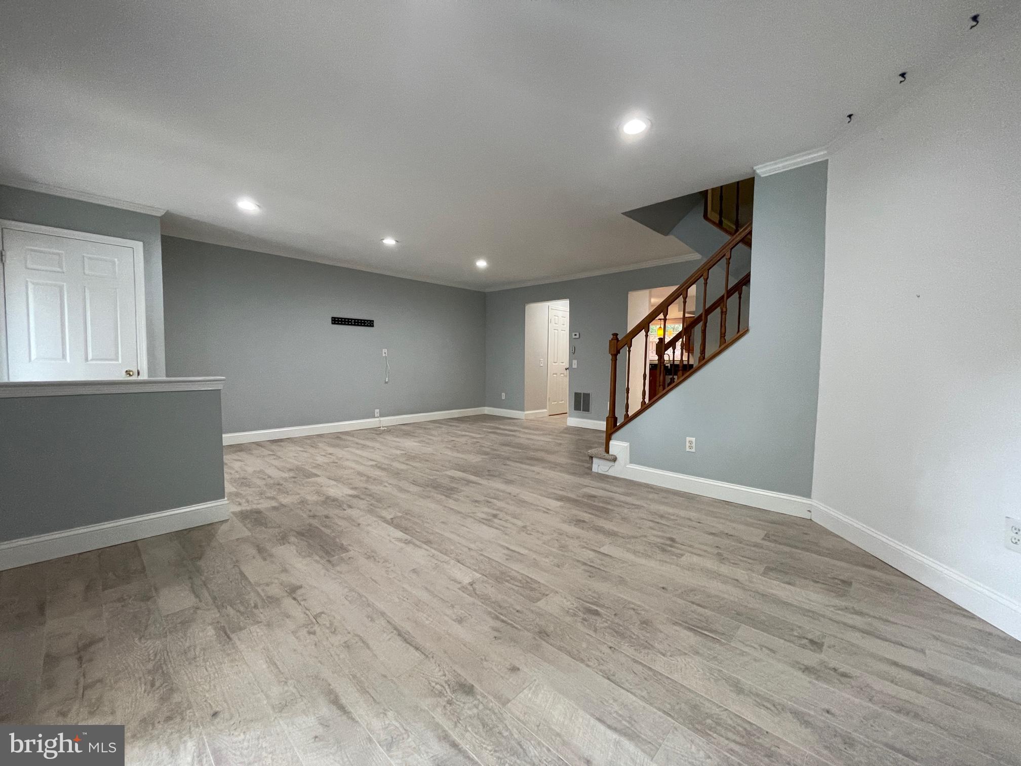 308 Crescendo Way Silver Spring, MD 20901 - Photo 7 of 26 a view of an empty room with wooden floor