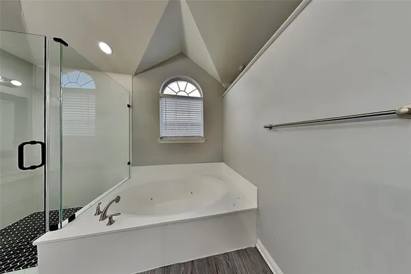 a bathroom with a bathtub and a shower
