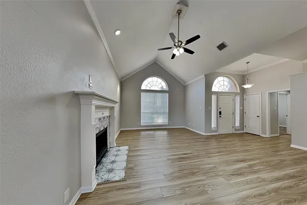 a view of empty room with wooden floor