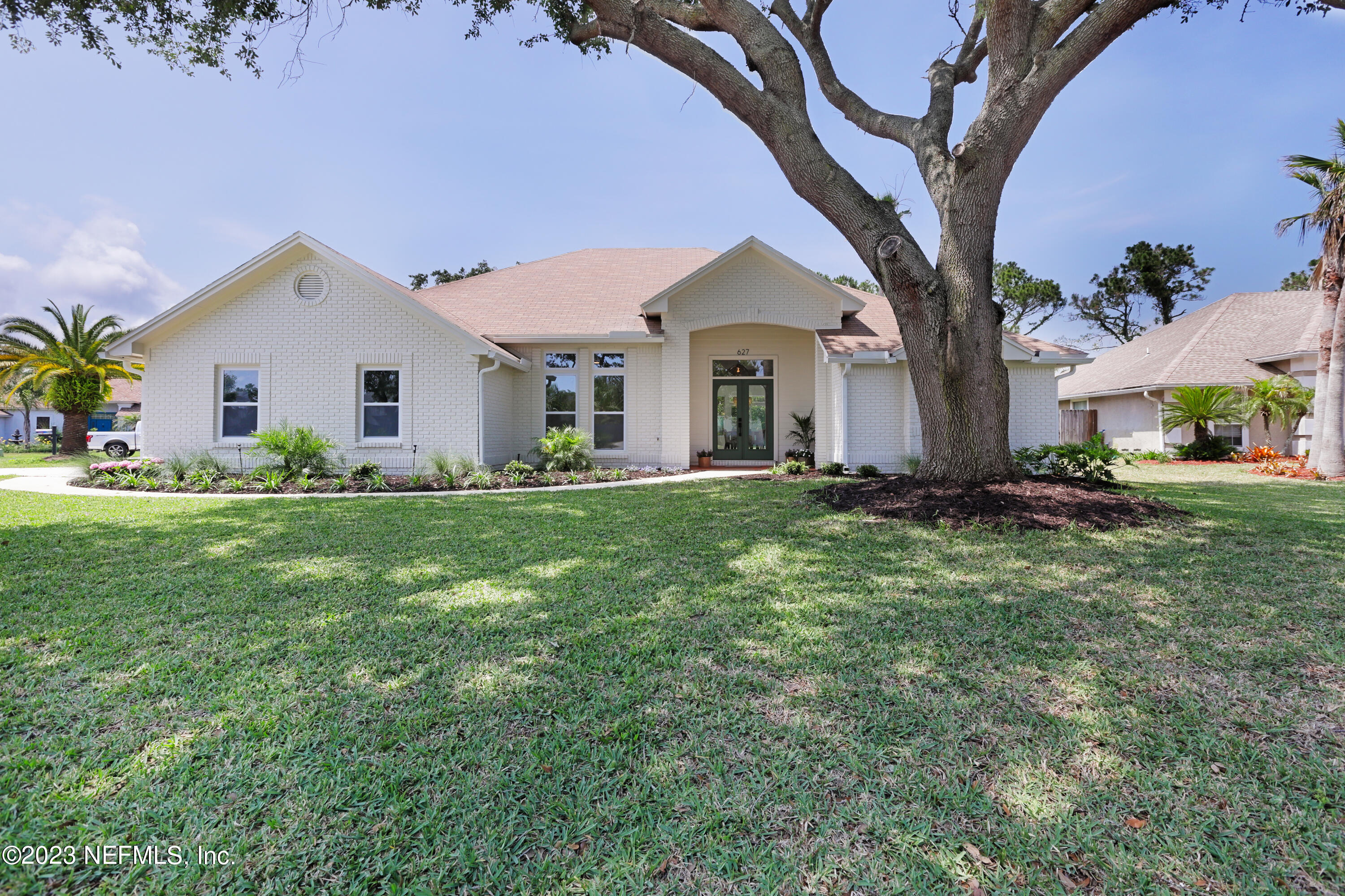 a front view of house with yard and green space