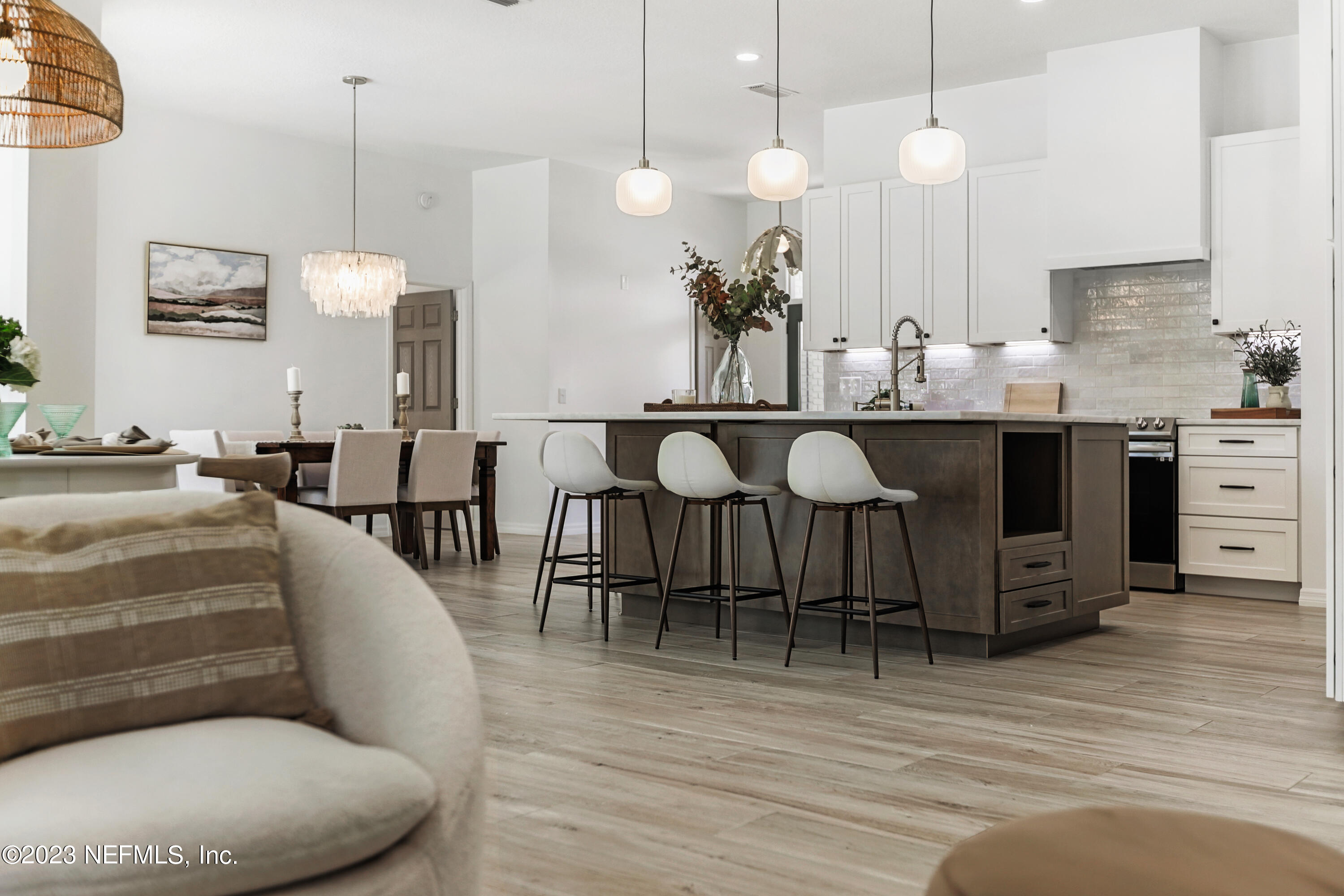 627 Cherry Street Neptune Beach, FL 32266 - Photo 11 of 51 a living room with furniture a wooden floor and a chandelier
