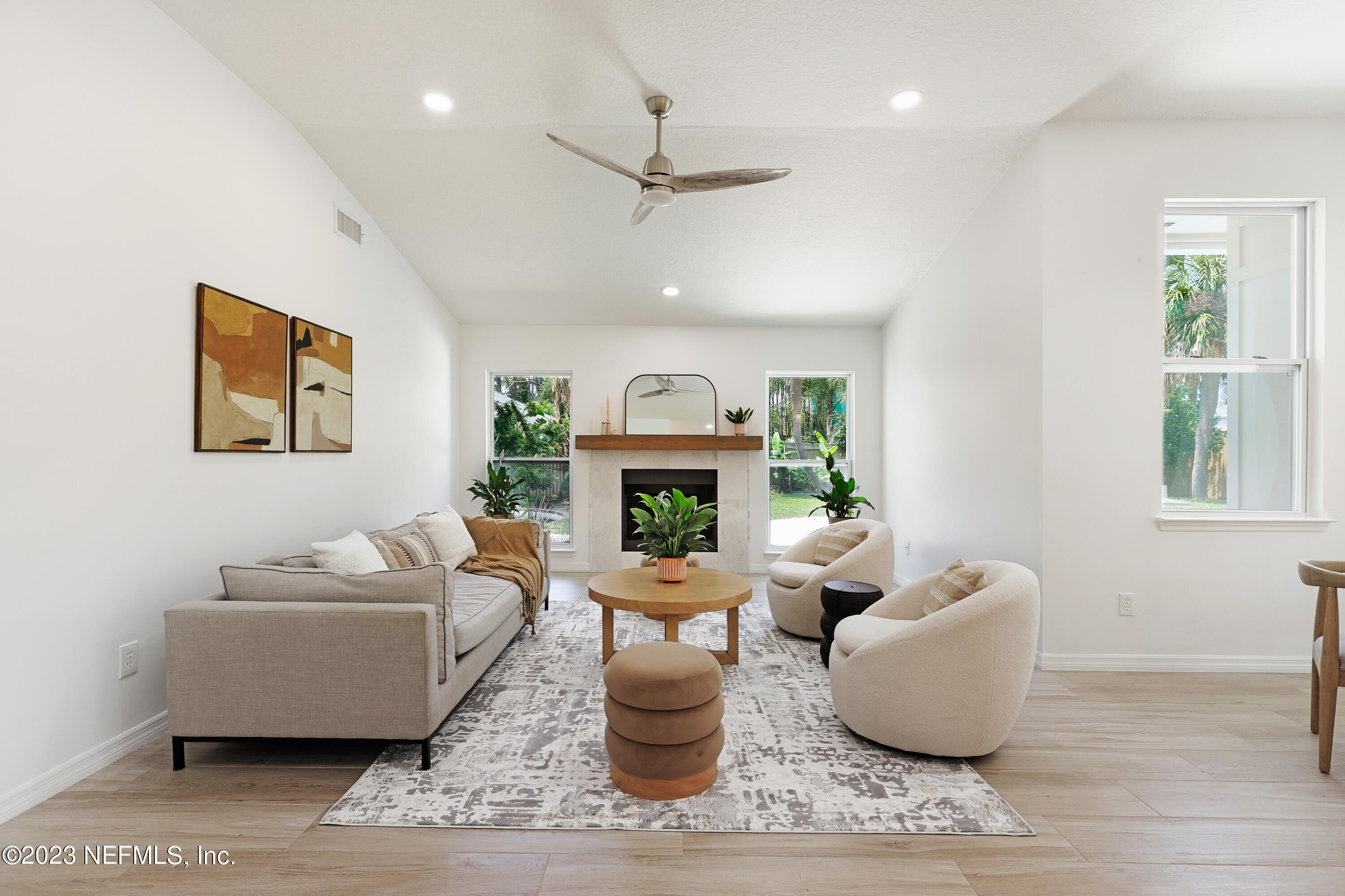 627 Cherry Street Neptune Beach, FL 32266 - Photo 18 of 51 a living room with furniture and a fireplace