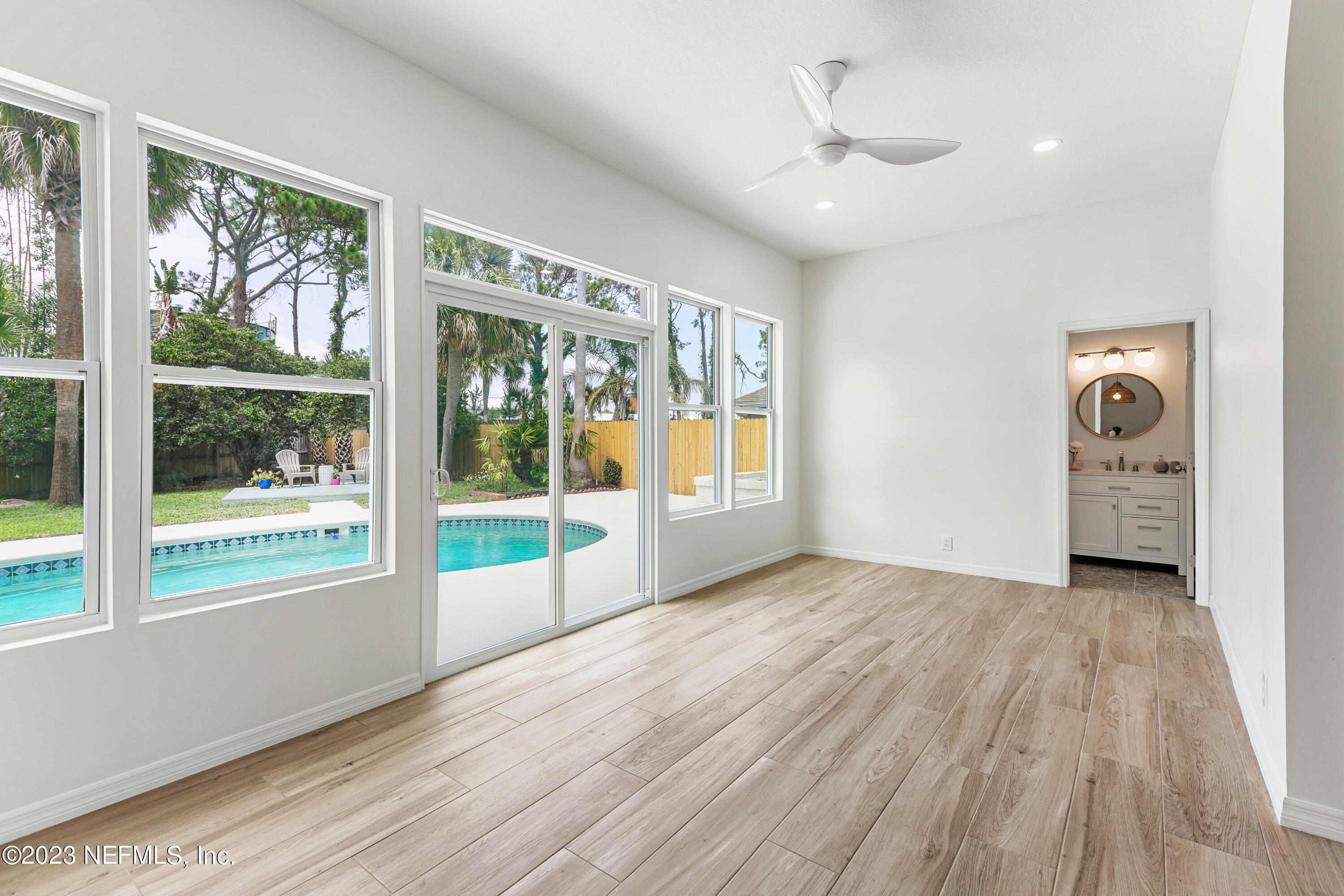 627 Cherry Street Neptune Beach, FL 32266 - Photo 22 of 51 a view of an empty room with a window and wooden floor
