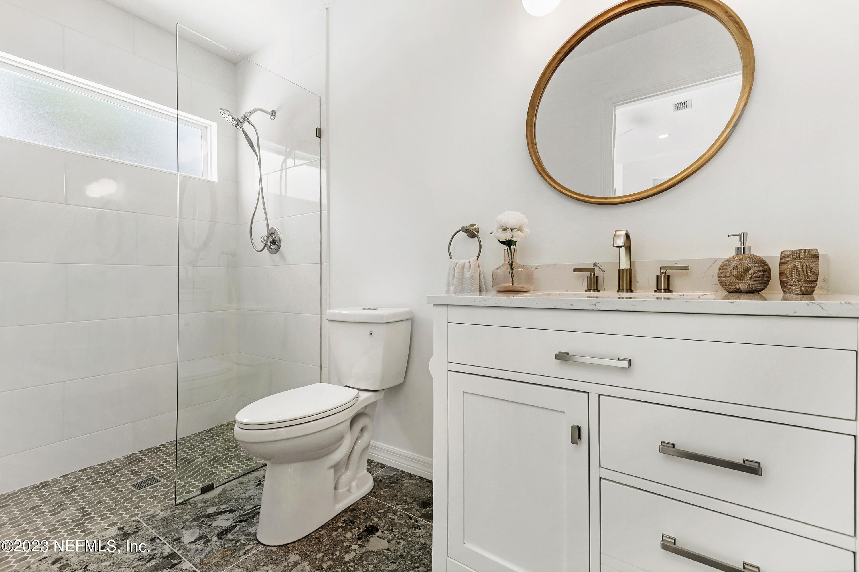 627 Cherry Street Neptune Beach, FL 32266 - Photo 24 of 51 a bathroom with a toilet a sink and a mirror