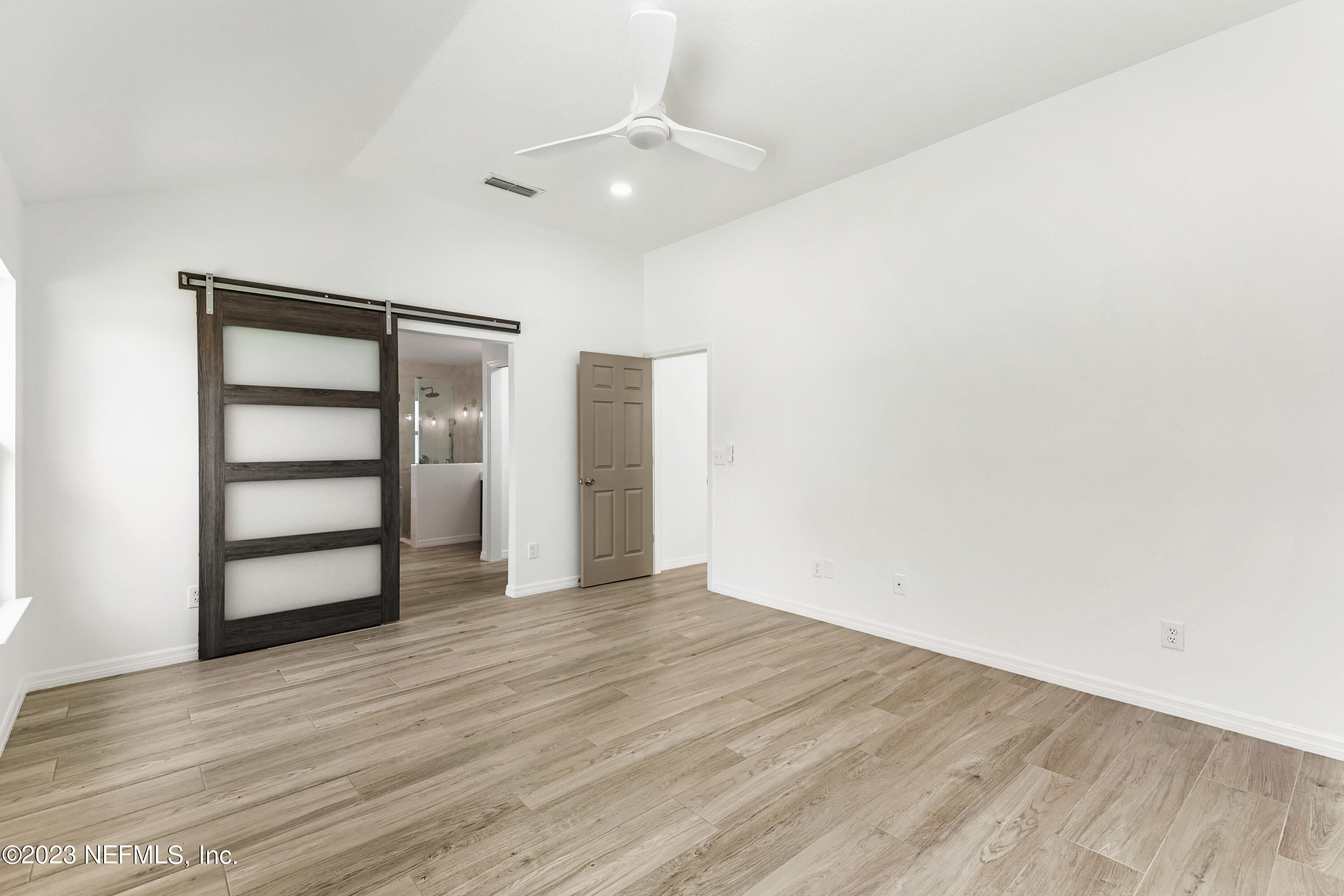 627 Cherry Street Neptune Beach, FL 32266 - Photo 27 of 51 a view of an empty room with a window and wooden floor