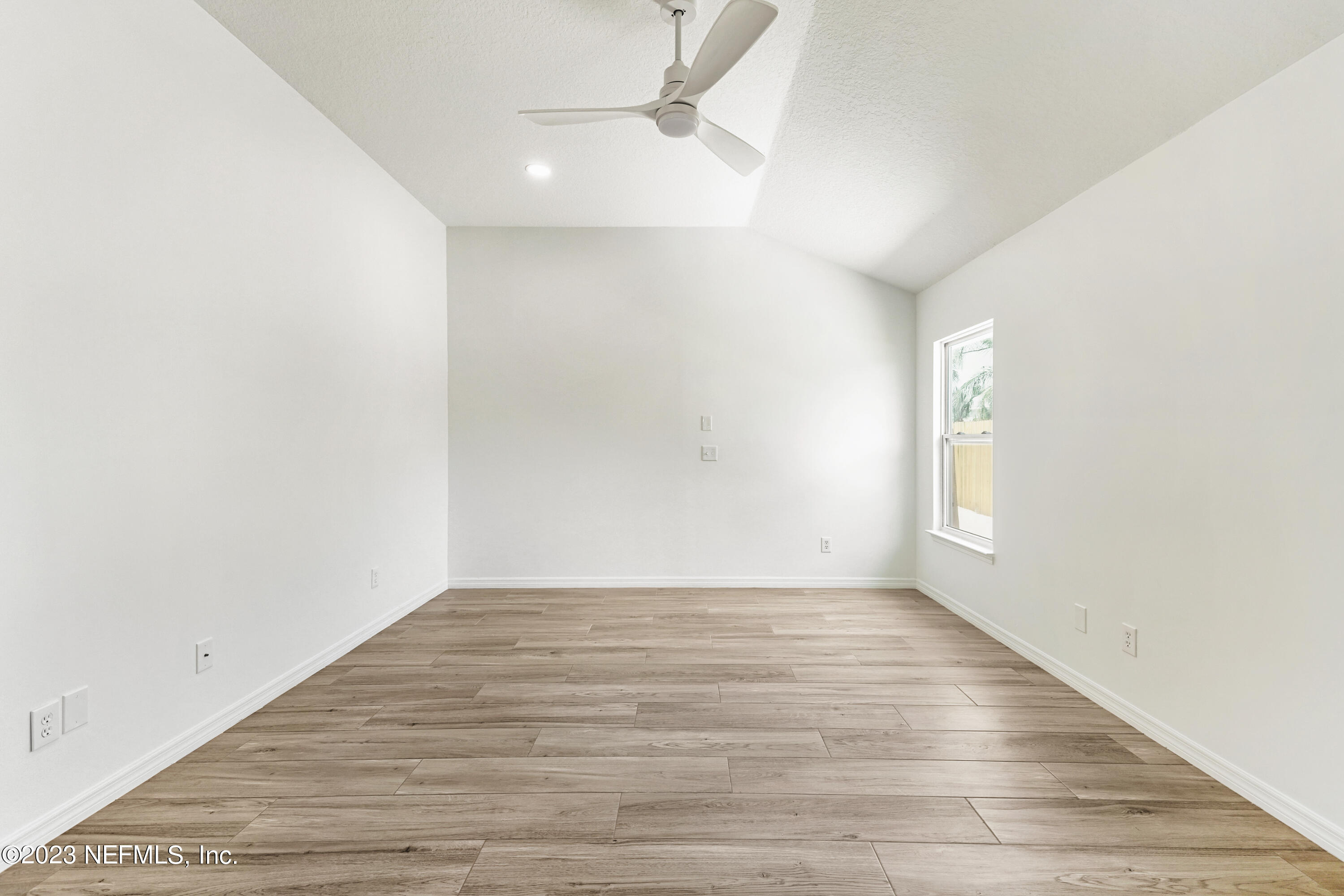 627 Cherry Street Neptune Beach, FL 32266 - Photo 28 of 51 a view of an empty room with wooden floor and a window