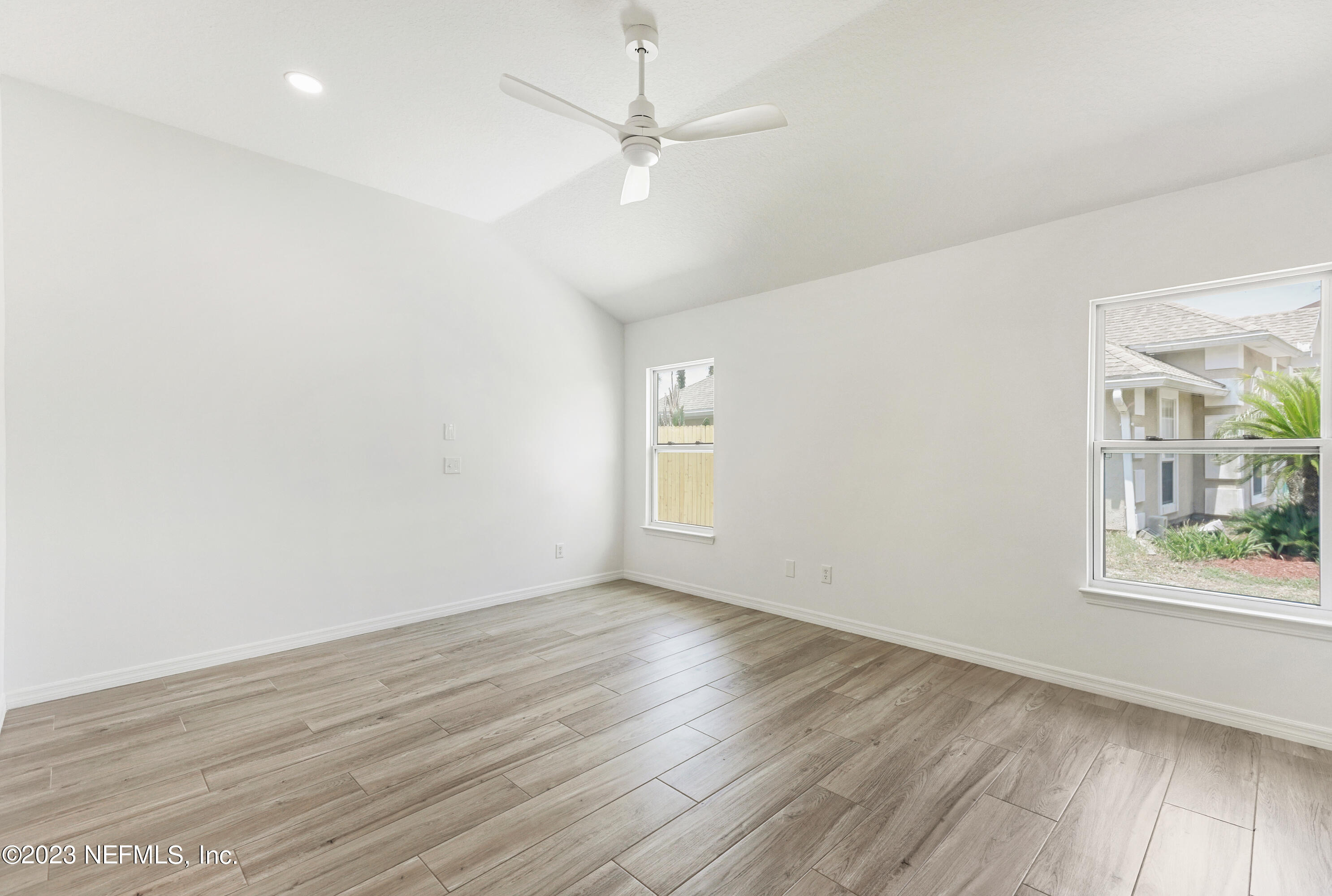 627 Cherry Street Neptune Beach, FL 32266 - Photo 29 of 51 wooden floor in an empty room with a window