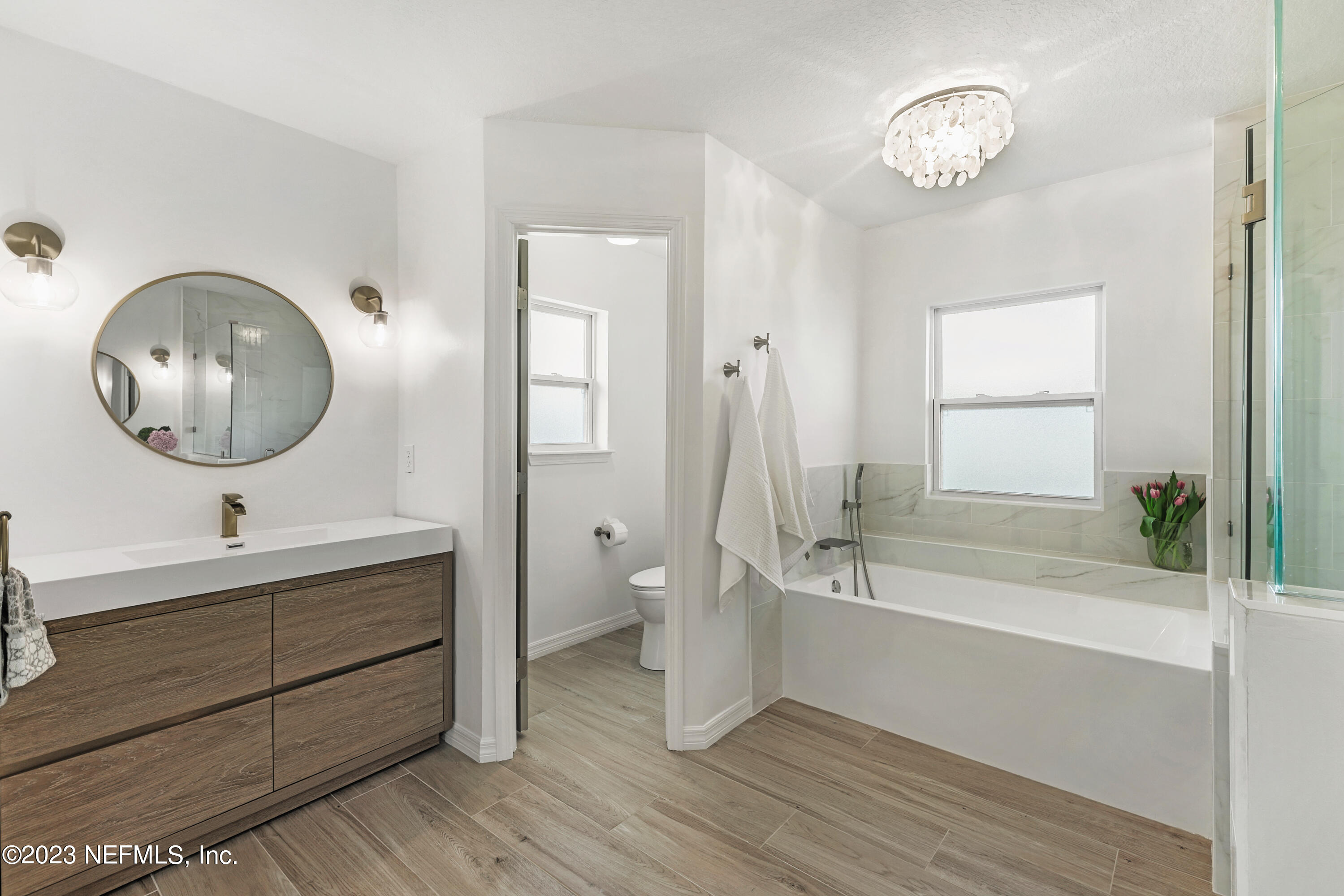 627 Cherry Street Neptune Beach, FL 32266 - Photo 32 of 51 a bathroom with a double vanity sink a mirror and a bathtub