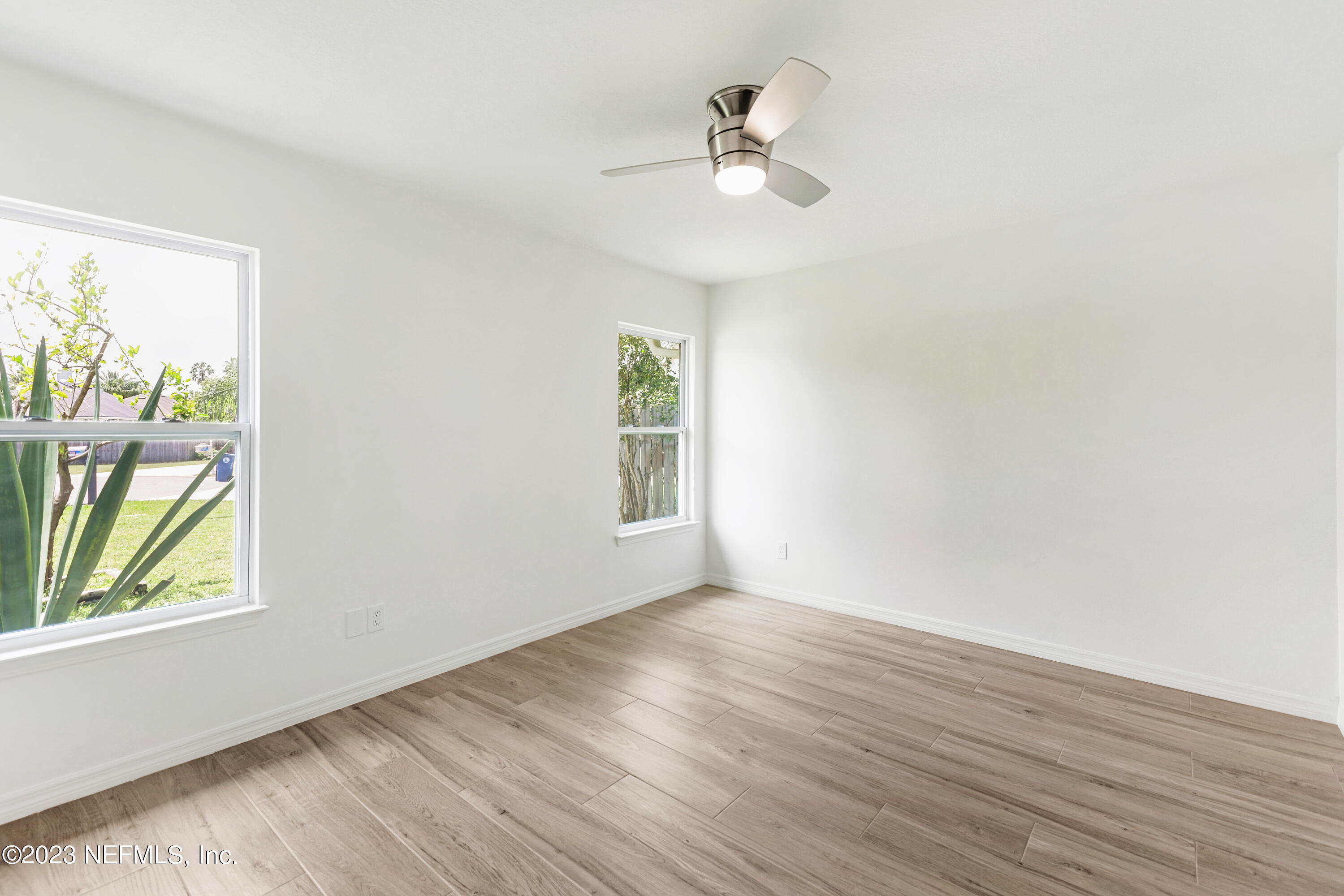 627 Cherry Street Neptune Beach, FL 32266 - Photo 39 of 51 wooden floor in an empty room with a window