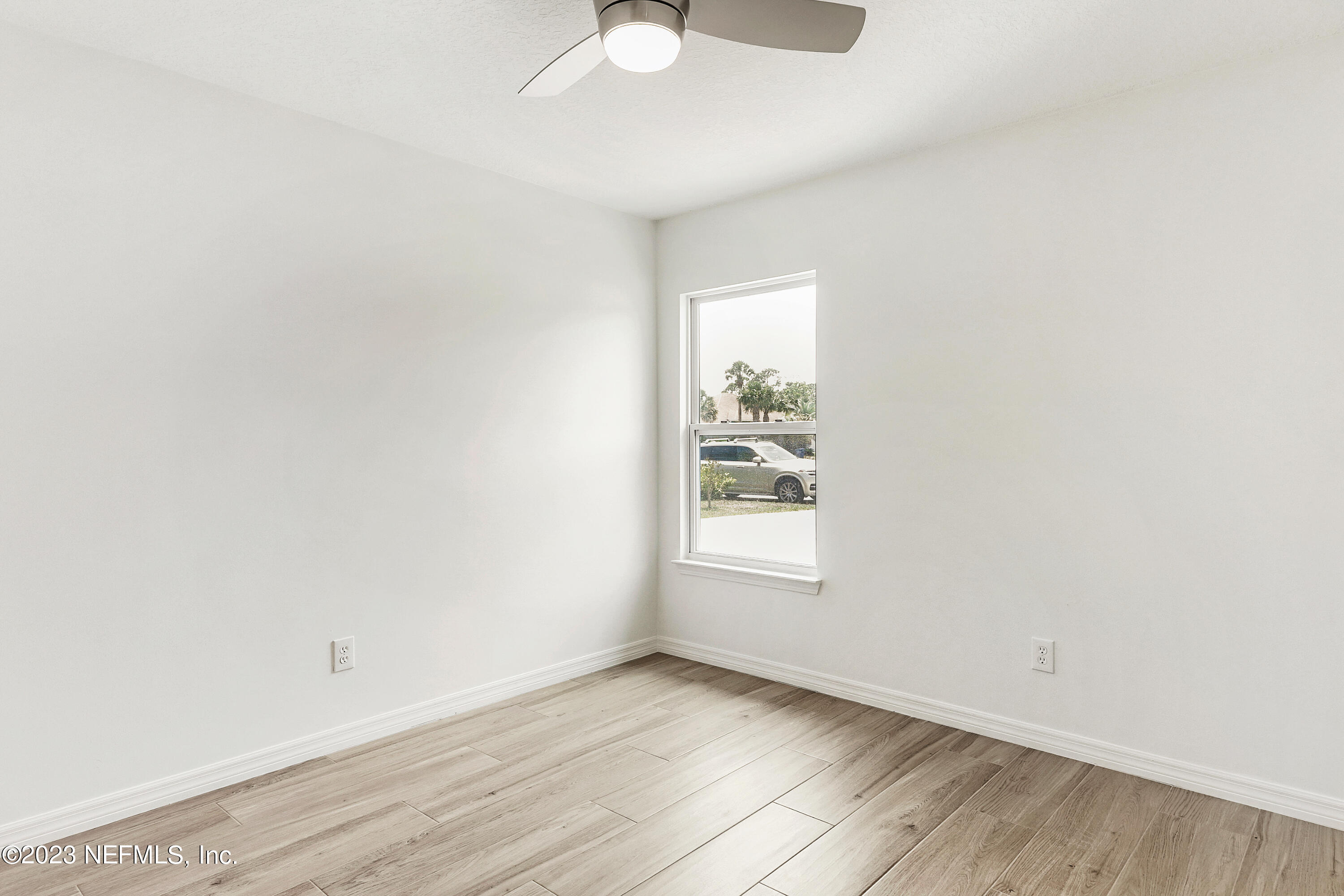 627 Cherry Street Neptune Beach, FL 32266 - Photo 40 of 51 an empty room with wooden floor and windows
