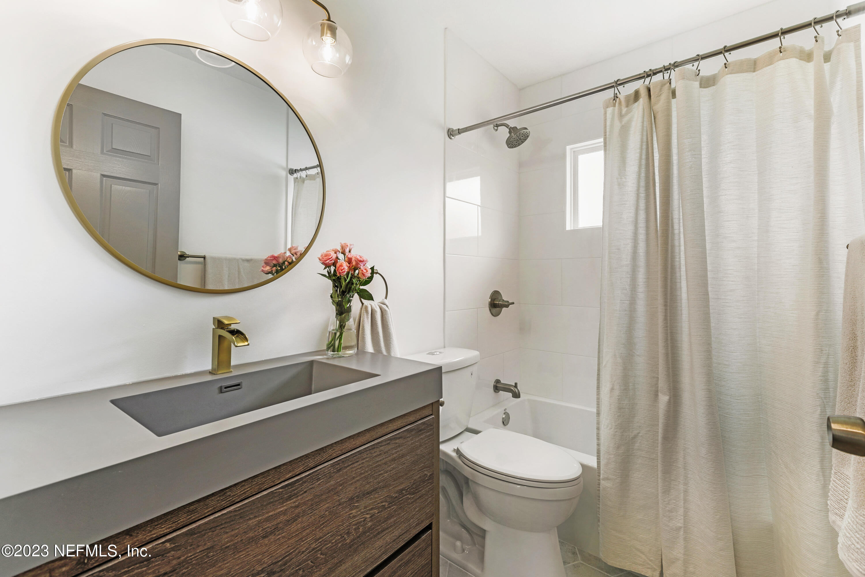 627 Cherry Street Neptune Beach, FL 32266 - Photo 41 of 51 a bathroom with a sink a toilet and a mirror