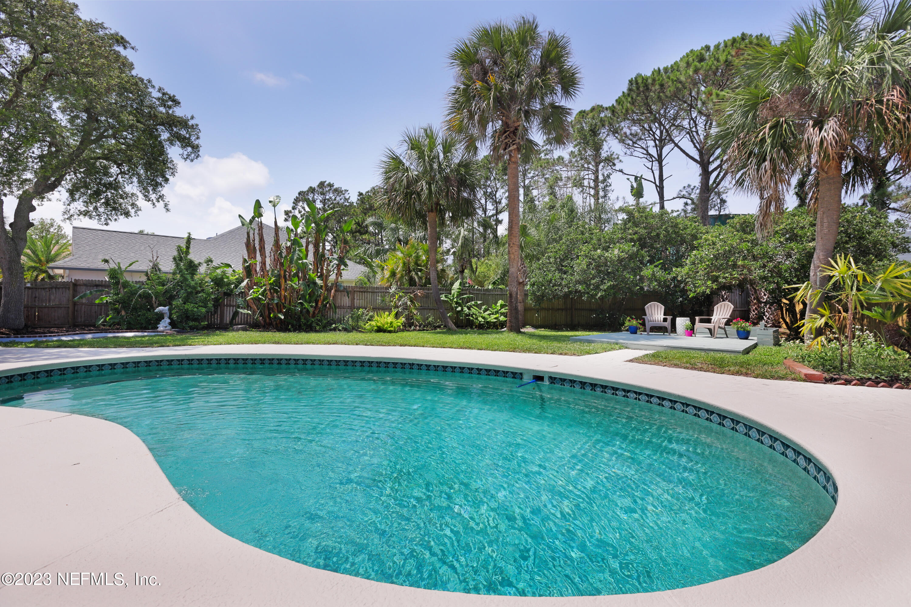627 Cherry Street Neptune Beach, FL 32266 - Photo 44 of 51 a view of a swimming pool with a yard