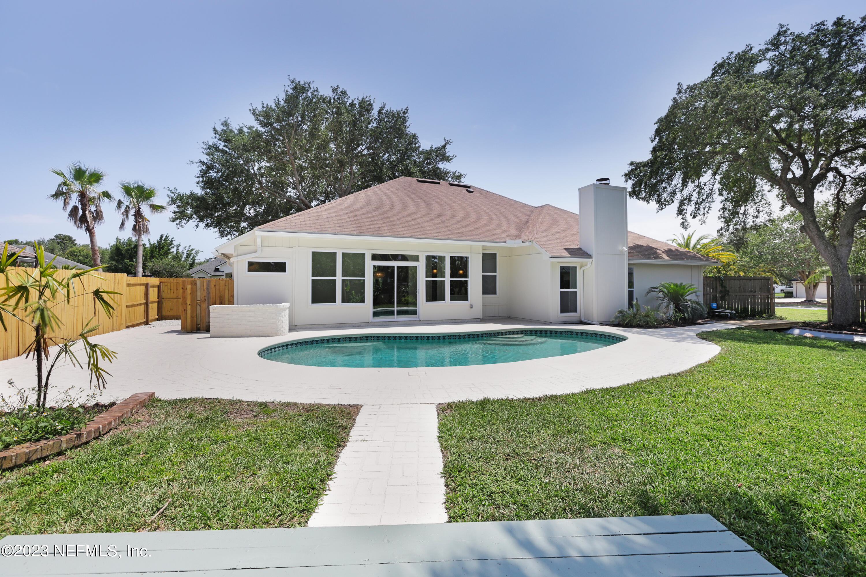 627 Cherry Street Neptune Beach, FL 32266 - Photo 45 of 51 a front view of a house with garden