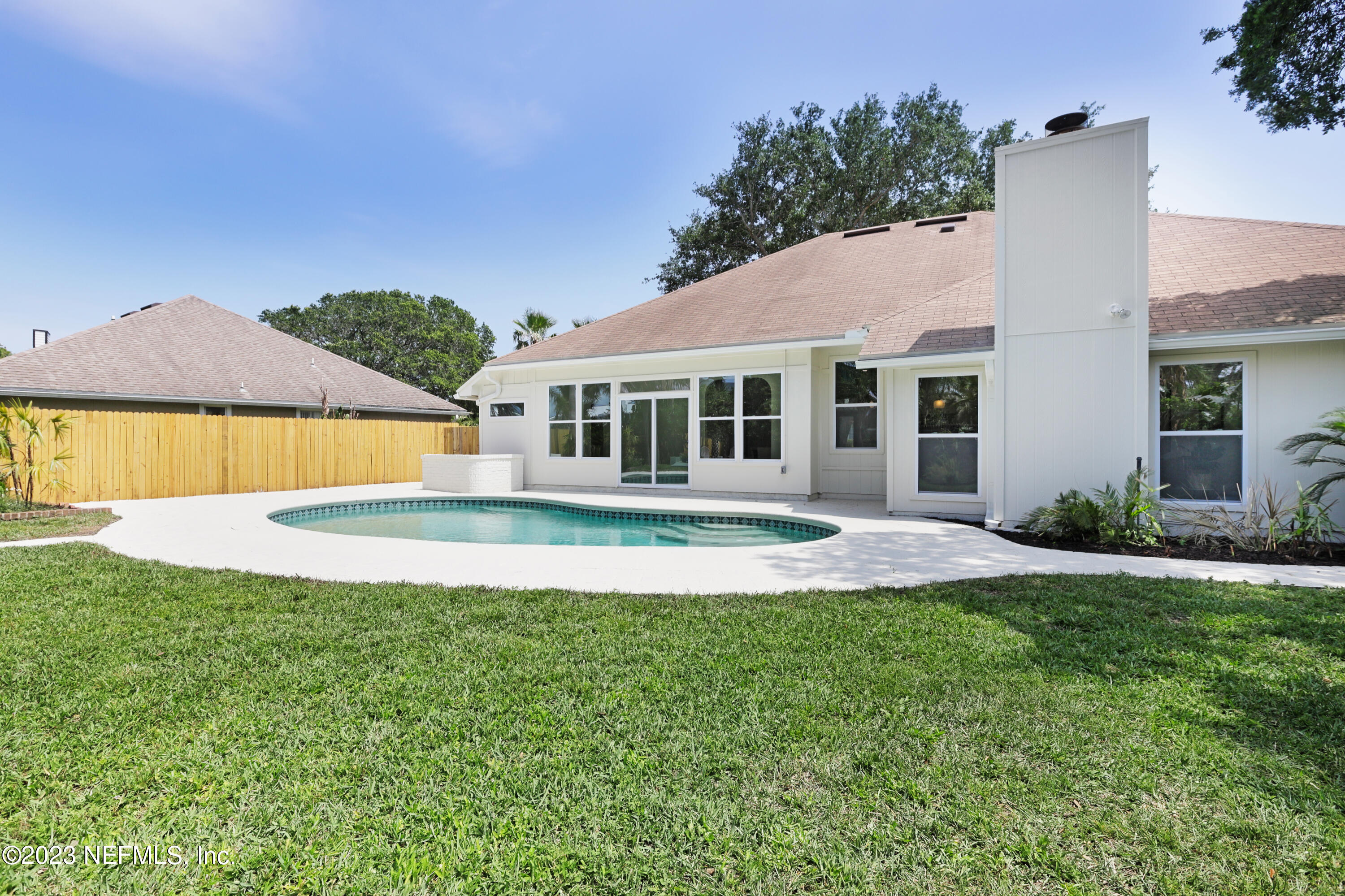 627 Cherry Street Neptune Beach, FL 32266 - Photo 47 of 51 a view of a house with a swimming pool and a yard