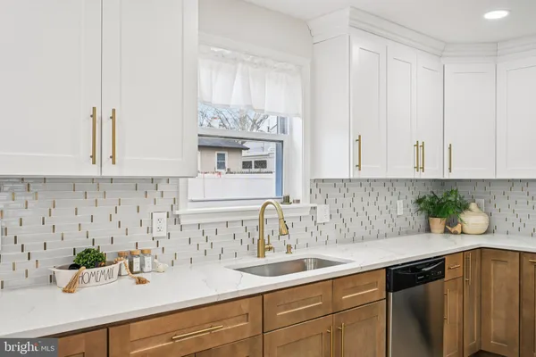 a kitchen with white cabinets and a sink
